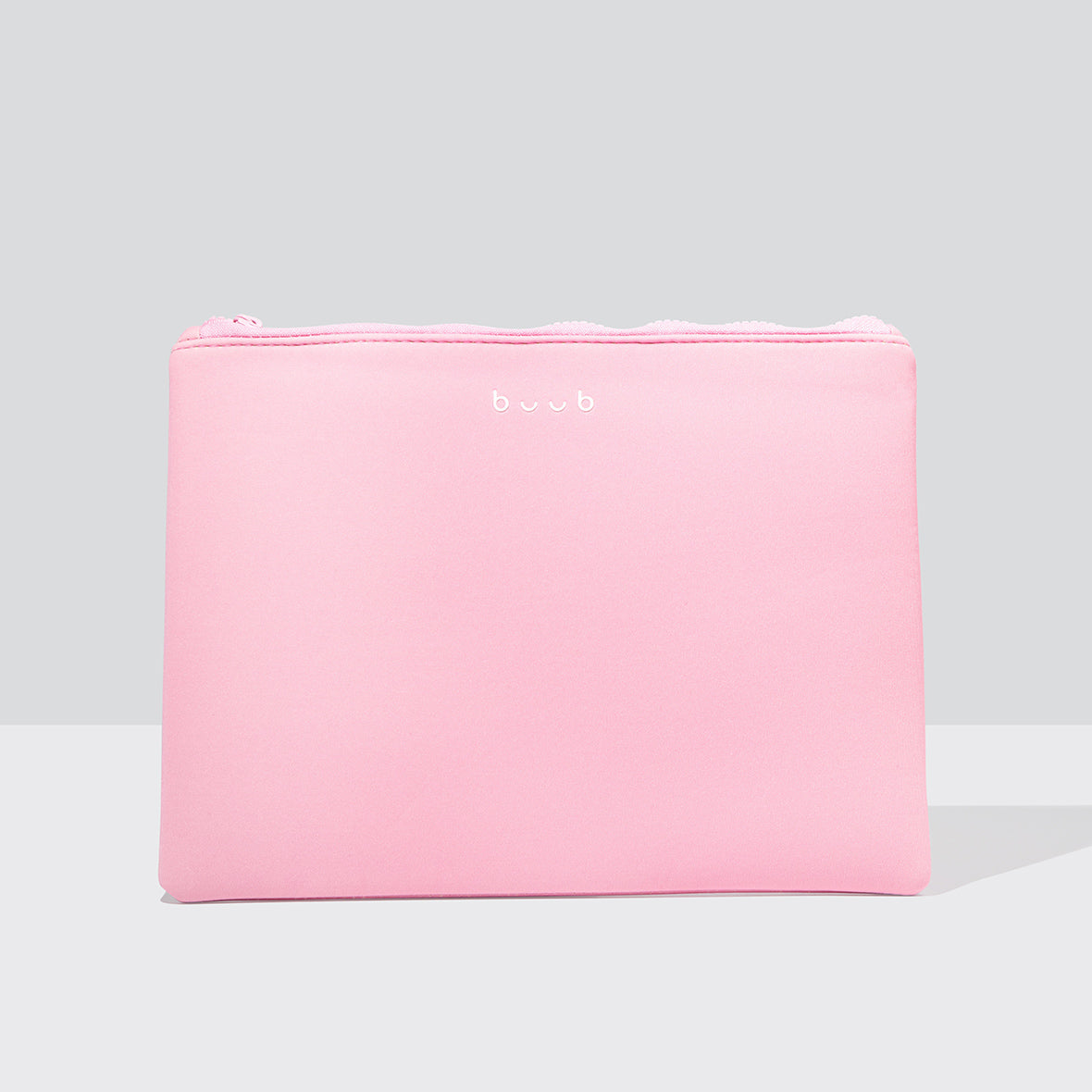 A soft pink Buub wash bag with a subtle white logo, perfect for storing beauty essentials and accessories. The rectangular cosmetic case is shown against a light grey background.