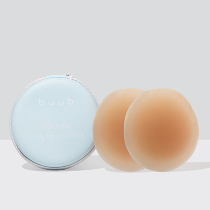 A pair of 10cm Buub reusable adhesive silicone nipple covers in tan. The large stick-on pasties provide secure coverage and come with a light blue travel case.