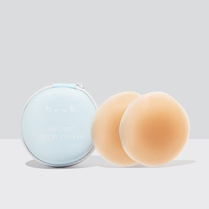 Buub's 8cm reusable adhesive silicone nipple covers in a tan shade. The stick-on pasties are displayed beside their protective light blue travel case.